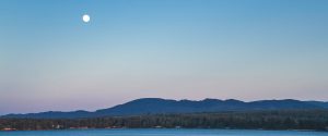 Moon rising in the summer over Rathtrevor Beach in Parksville